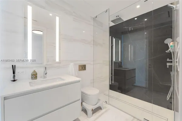 a bathroom with a sink toilet and shower