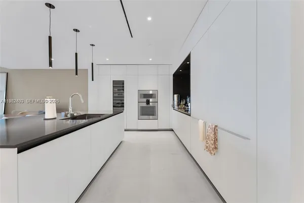 a kitchen with stainless steel appliances a sink a stove and a refrigerator