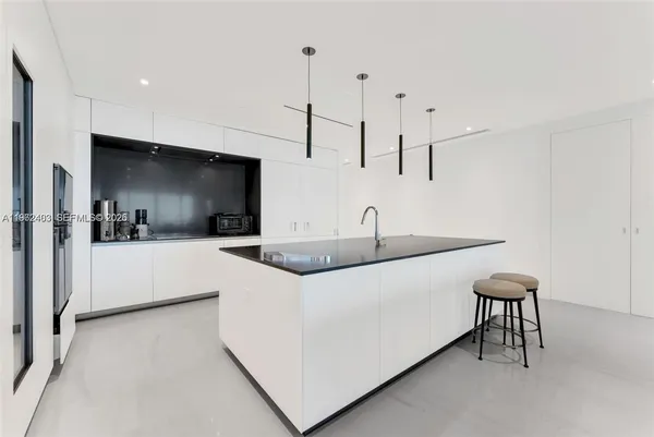a kitchen with stainless steel appliances a sink and a refrigerator