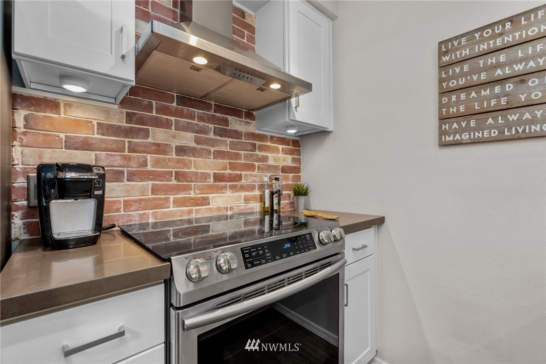 769 Hayes Street, Unit 609 Seattle, WA 98109 - Photo 12 of 26 a stove top oven sitting inside of a kitchen