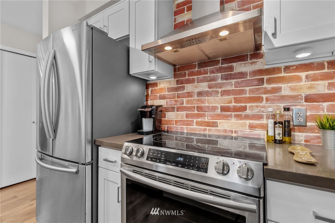 769 Hayes Street, Unit 609 Seattle, WA 98109 - Photo 13 of 26 a stove top oven sitting inside of a kitchen