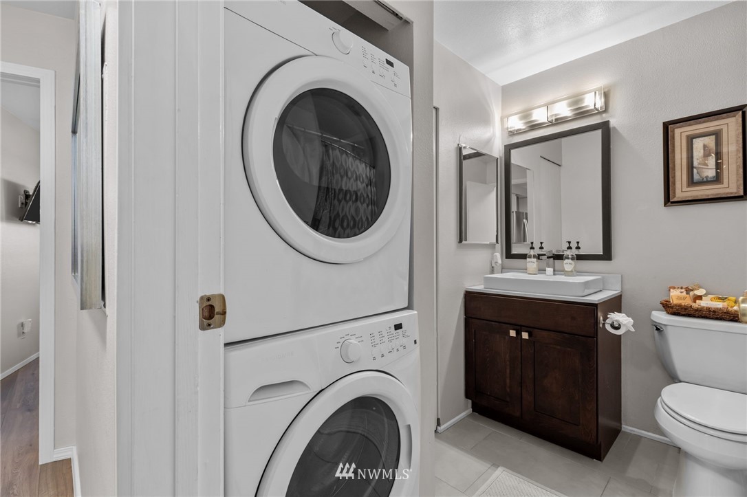 769 Hayes Street, Unit 609 Seattle, WA 98109 - Photo 16 of 26 a spacious bathroom with a toilet sink and mirror