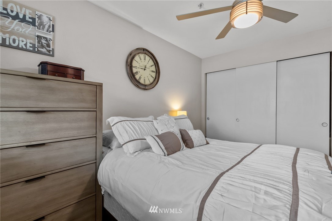 769 Hayes Street, Unit 609 Seattle, WA 98109 - Photo 20 of 26 a bedroom with a bed and a chandelier