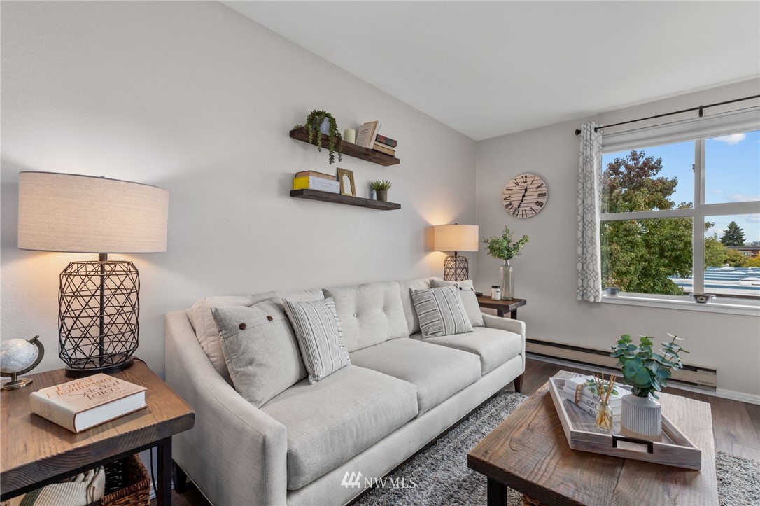 769 Hayes Street, Unit 609 Seattle, WA 98109 - Photo 3 of 26 a living room with furniture and a large window