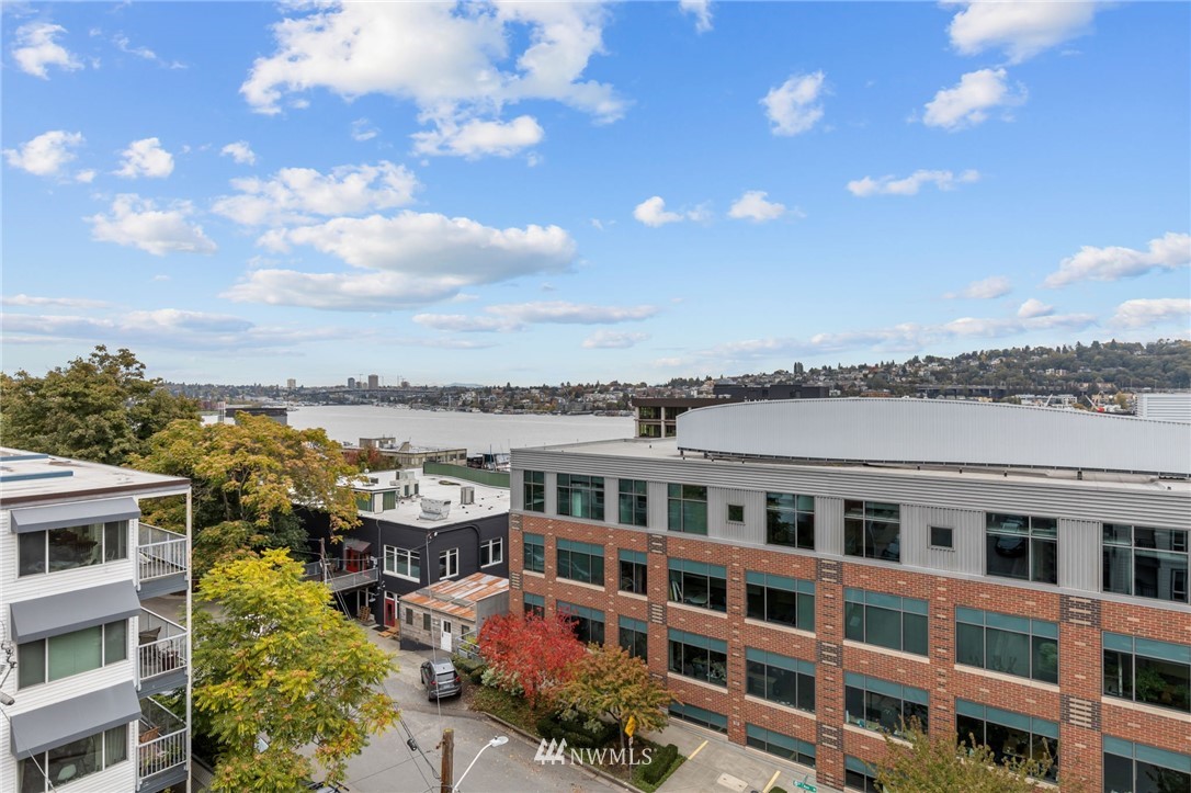 769 Hayes Street, Unit 609 Seattle, WA 98109 - Photo 22 of 26 a view of a building with many windows and a yard