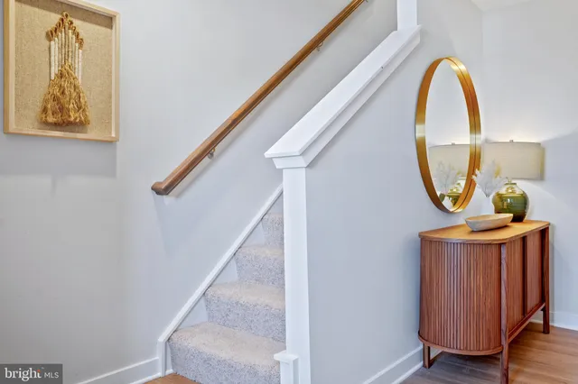 a view of a hallway with entryway wooden floor and front door