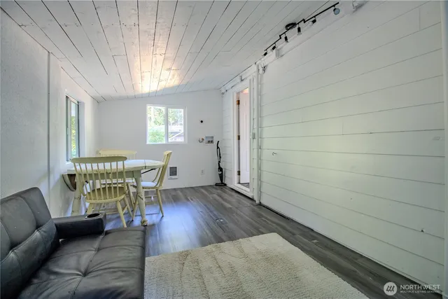 a bed sitting in a spacious bedroom next to a window