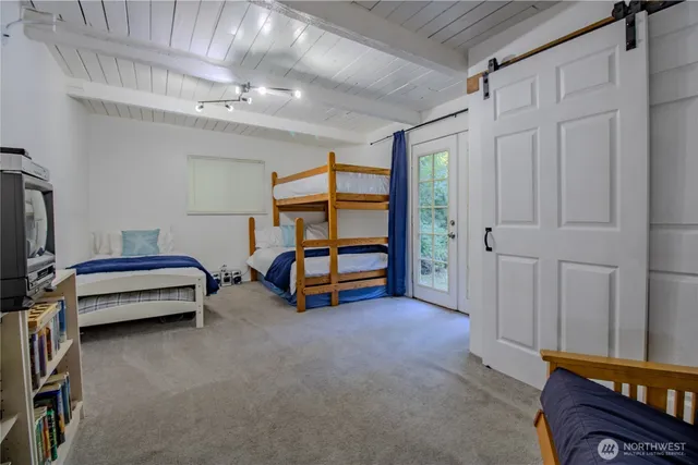 a bedroom with a bed and a chair