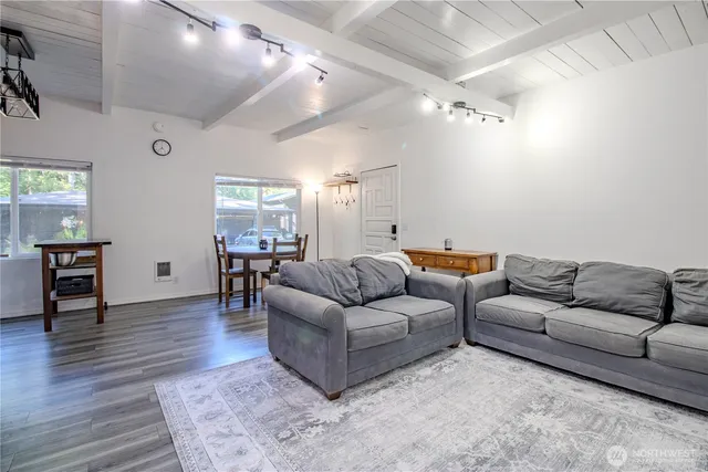 a bedroom with a bed couch and window