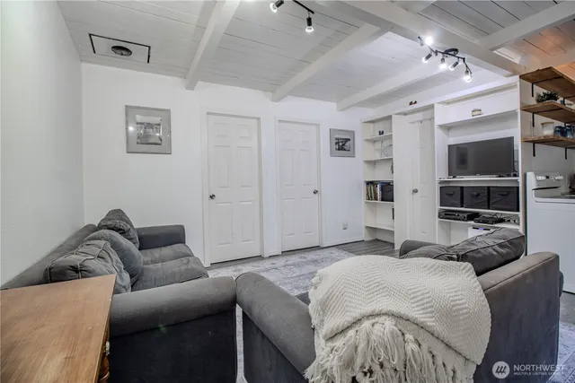 a living room with furniture and view of kitchen