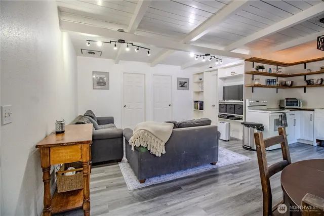 a dining room with furniture and wooden floor