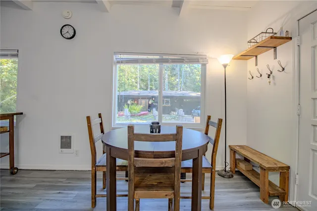a kitchen with stainless steel appliances a white cabinets and a wooden floors
