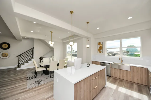 a large kitchen with lots of counter space a sink a window and stainless steel appliances