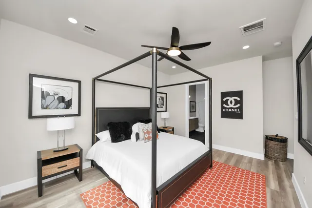 a bedroom with a bed and a lamp