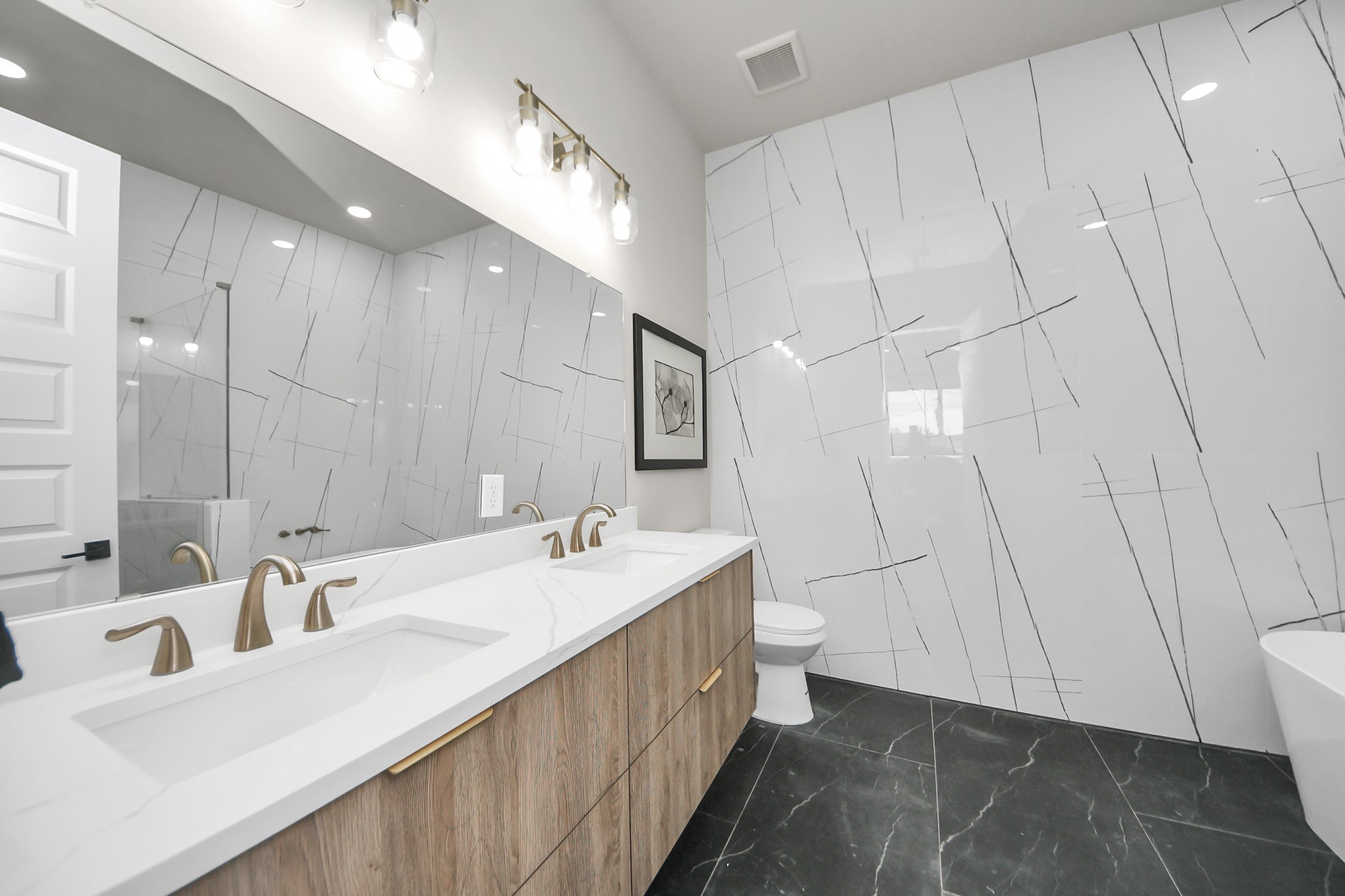 2016 Blodgett Street Houston, TX 77004 - Photo 31 of 49 a bathroom with double vanity and a mirror