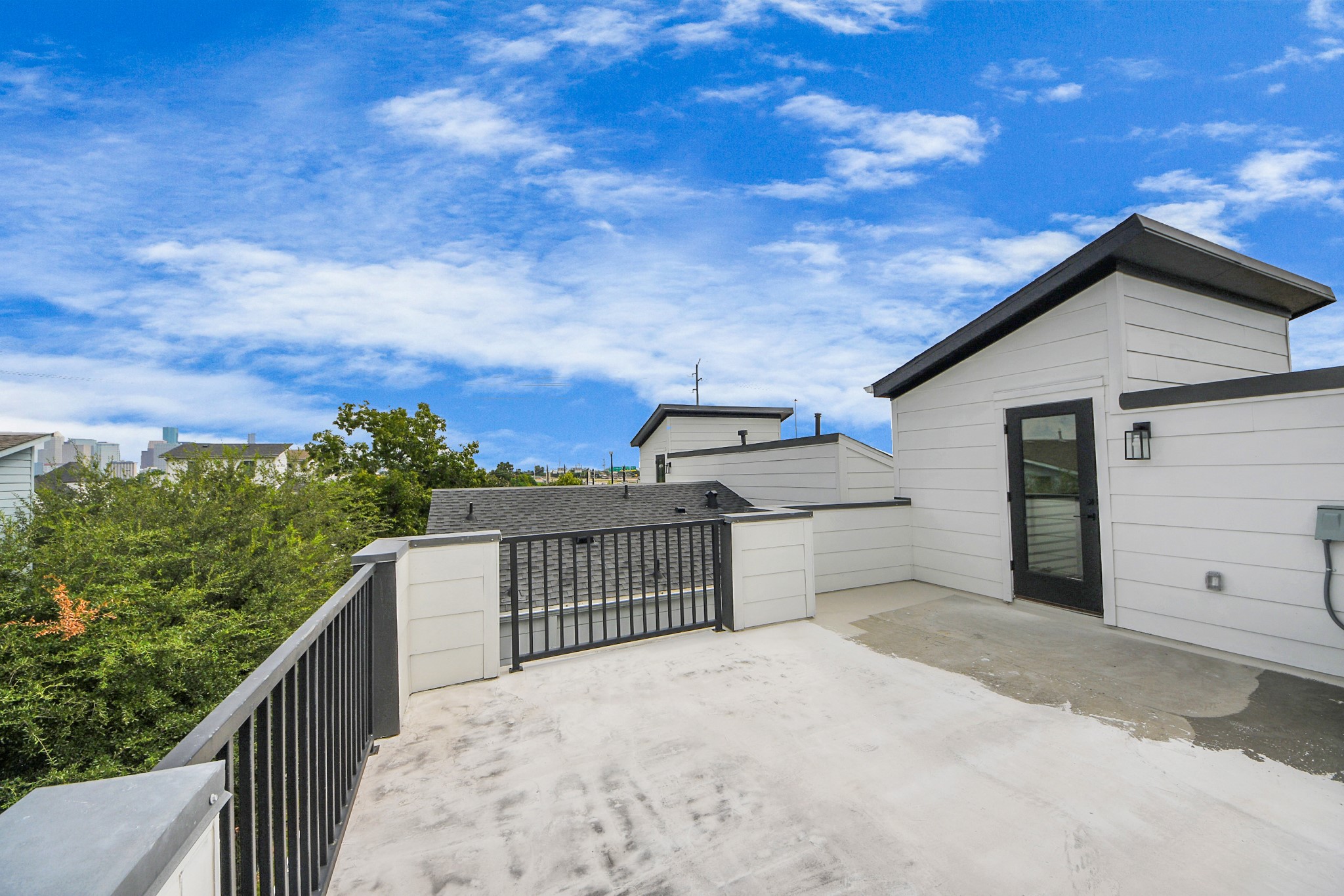 2016 Blodgett Street Houston, TX 77004 - Photo 43 of 49 a view of a roof deck with wooden fence and trees