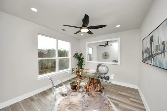 a living room with furniture a window and a chandelier