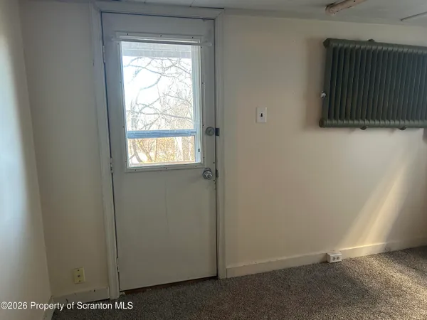 a view of an entryway with wooden floor