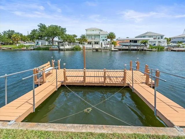 a view of a house with a yard and lake view