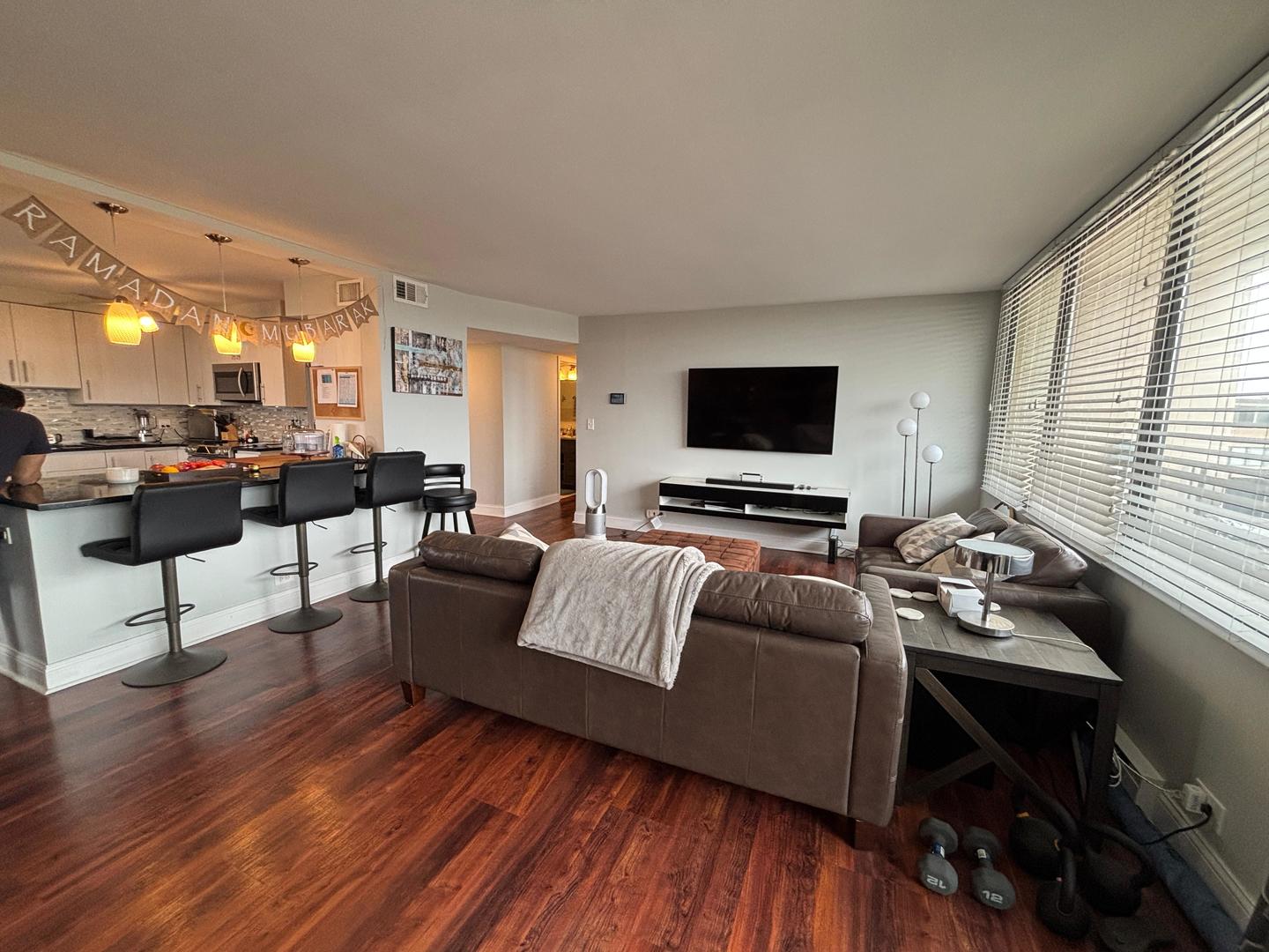 101 Bar Harbour Road, Unit 6M Schaumburg, IL 60193 - Photo 12 of 29 a living room with furniture and a flat screen tv