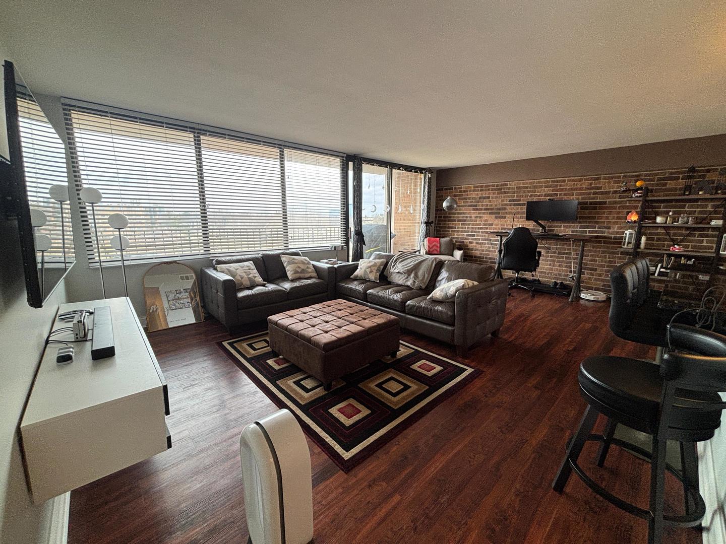 101 Bar Harbour Road, Unit 6M Schaumburg, IL 60193 - Photo 16 of 29 a living room with furniture and a floor to ceiling window