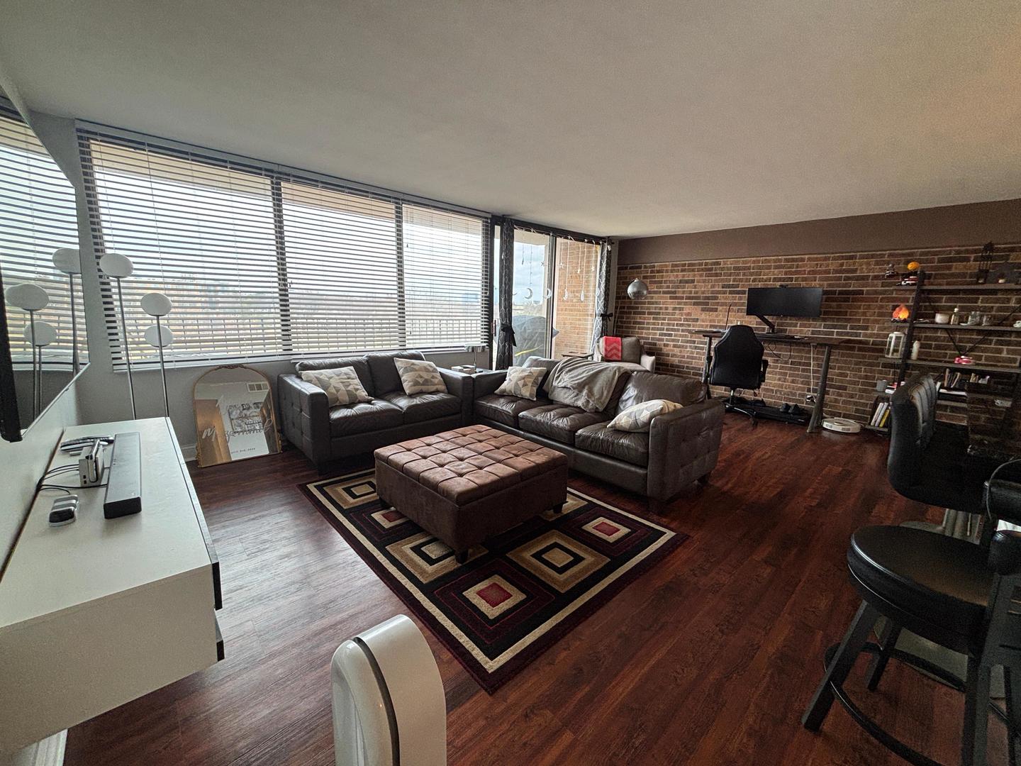 101 Bar Harbour Road, Unit 6M Schaumburg, IL 60193 - Photo 18 of 29 a living room with furniture and a floor to ceiling window