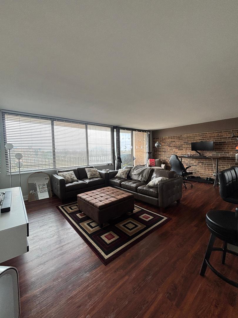 101 Bar Harbour Road, Unit 6M Schaumburg, IL 60193 - Photo 2 of 29 a living room with furniture a rug and a large window