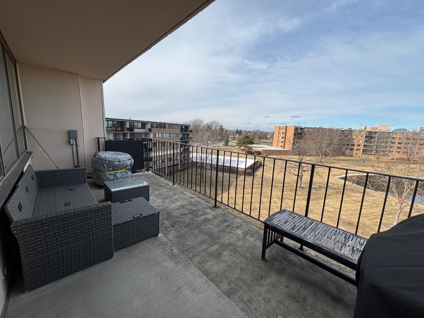101 Bar Harbour Road, Unit 6M Schaumburg, IL 60193 - Photo 22 of 29 a balcony with furniture and city view