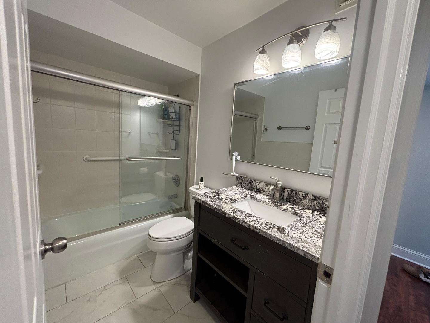 101 Bar Harbour Road, Unit 6M Schaumburg, IL 60193 - Photo 28 of 29 a bathroom with a granite countertop sink toilet and shower
