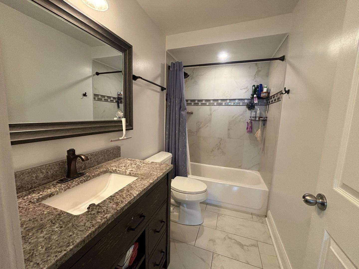 101 Bar Harbour Road, Unit 6M Schaumburg, IL 60193 - Photo 29 of 29 a bathroom with a granite countertop sink a toilet and shower
