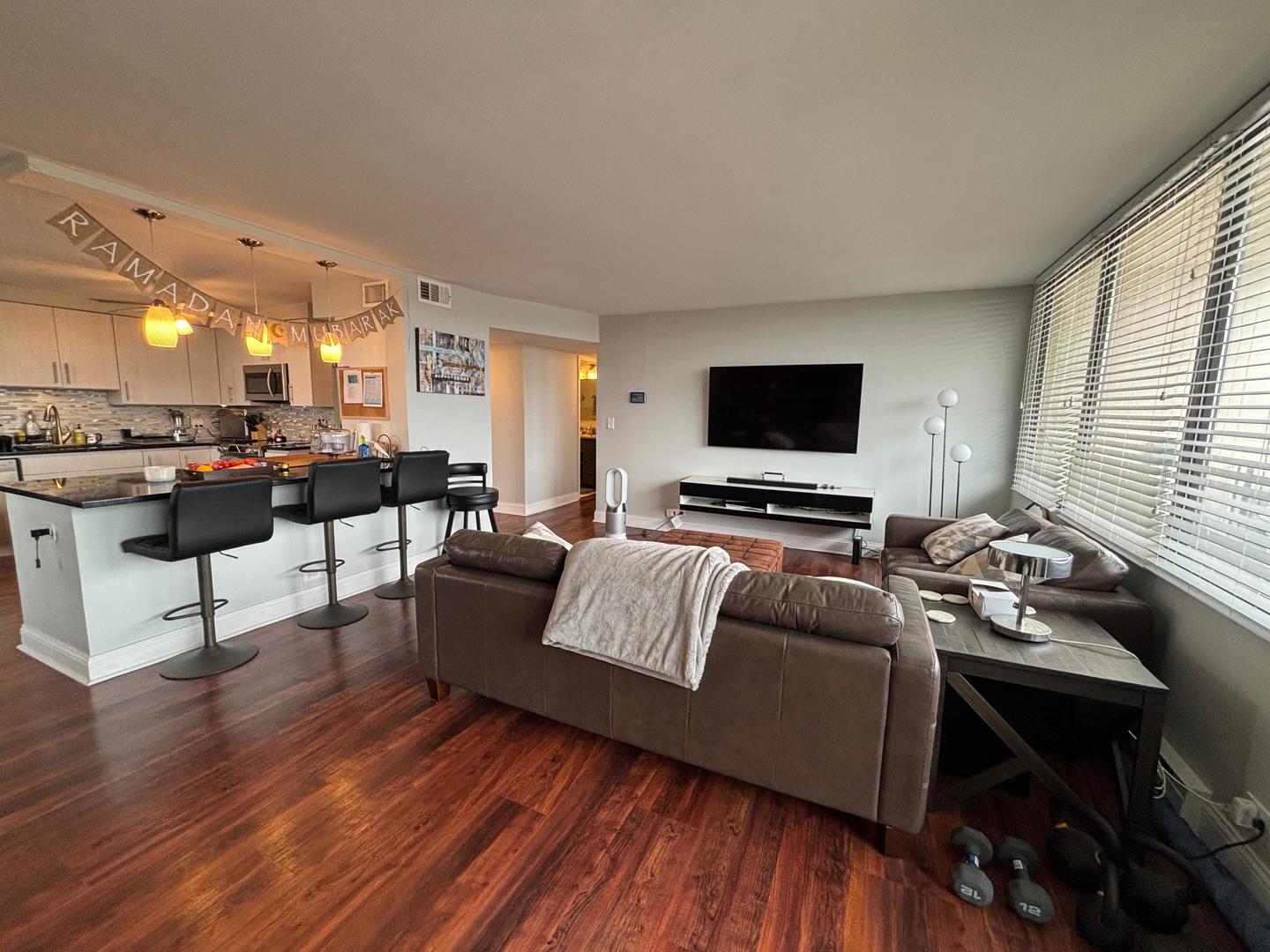 101 Bar Harbour Road, Unit 6M Schaumburg, IL 60193 - Photo 8 of 29 a living room with furniture and a flat screen tv