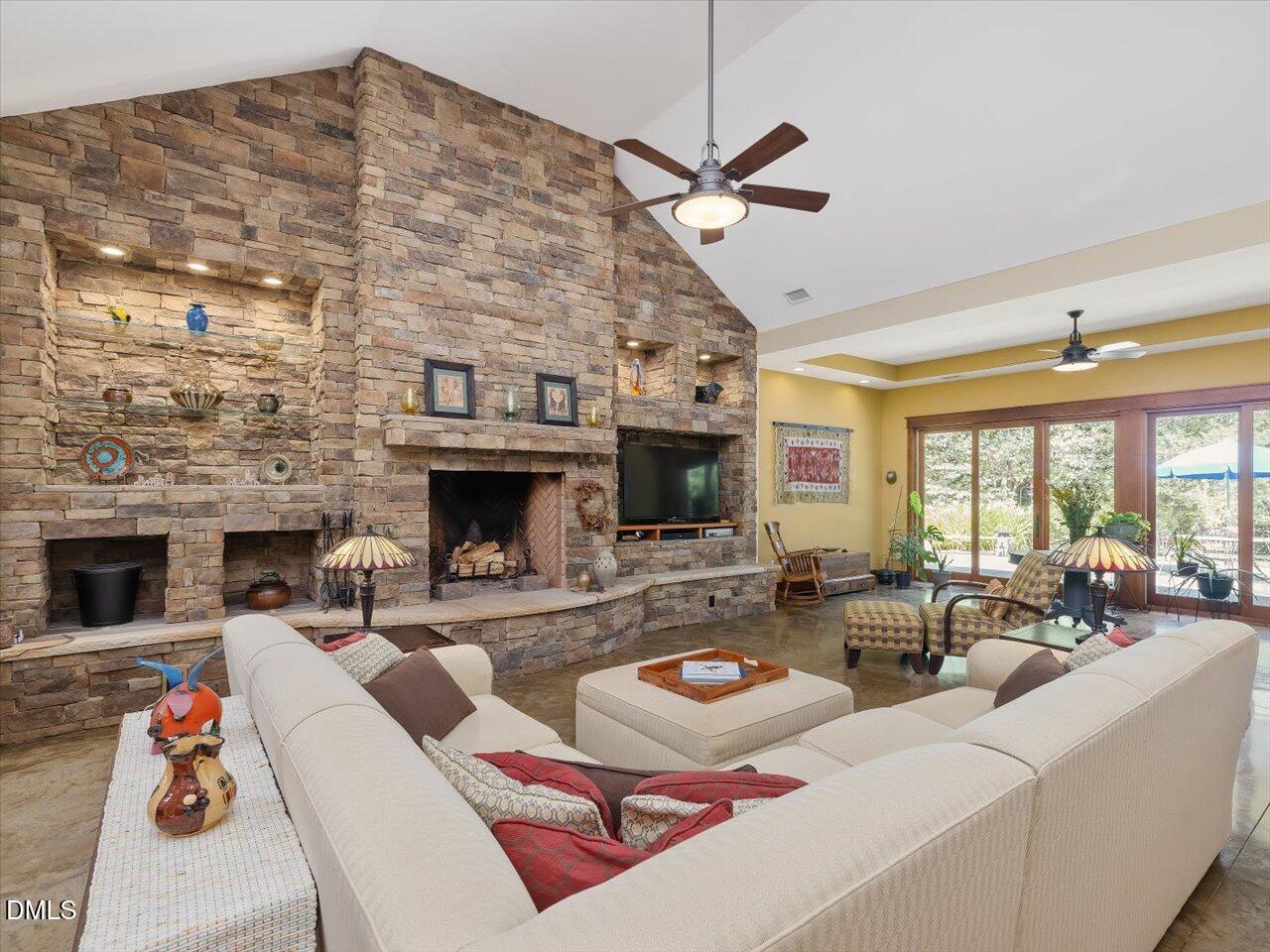1210 Manco Dairy Road Pittsboro, NC 27312 - Photo 13 of 99 a living room with furniture a fireplace and a flat screen tv