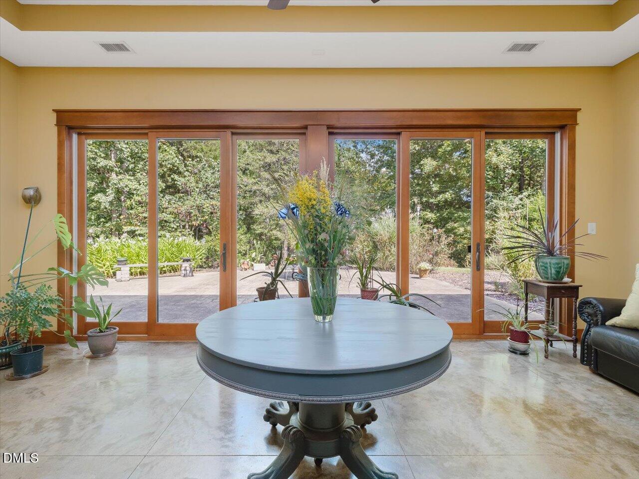 1210 Manco Dairy Road Pittsboro, NC 27312 - Photo 17 of 99 a dining room with glass door and a table