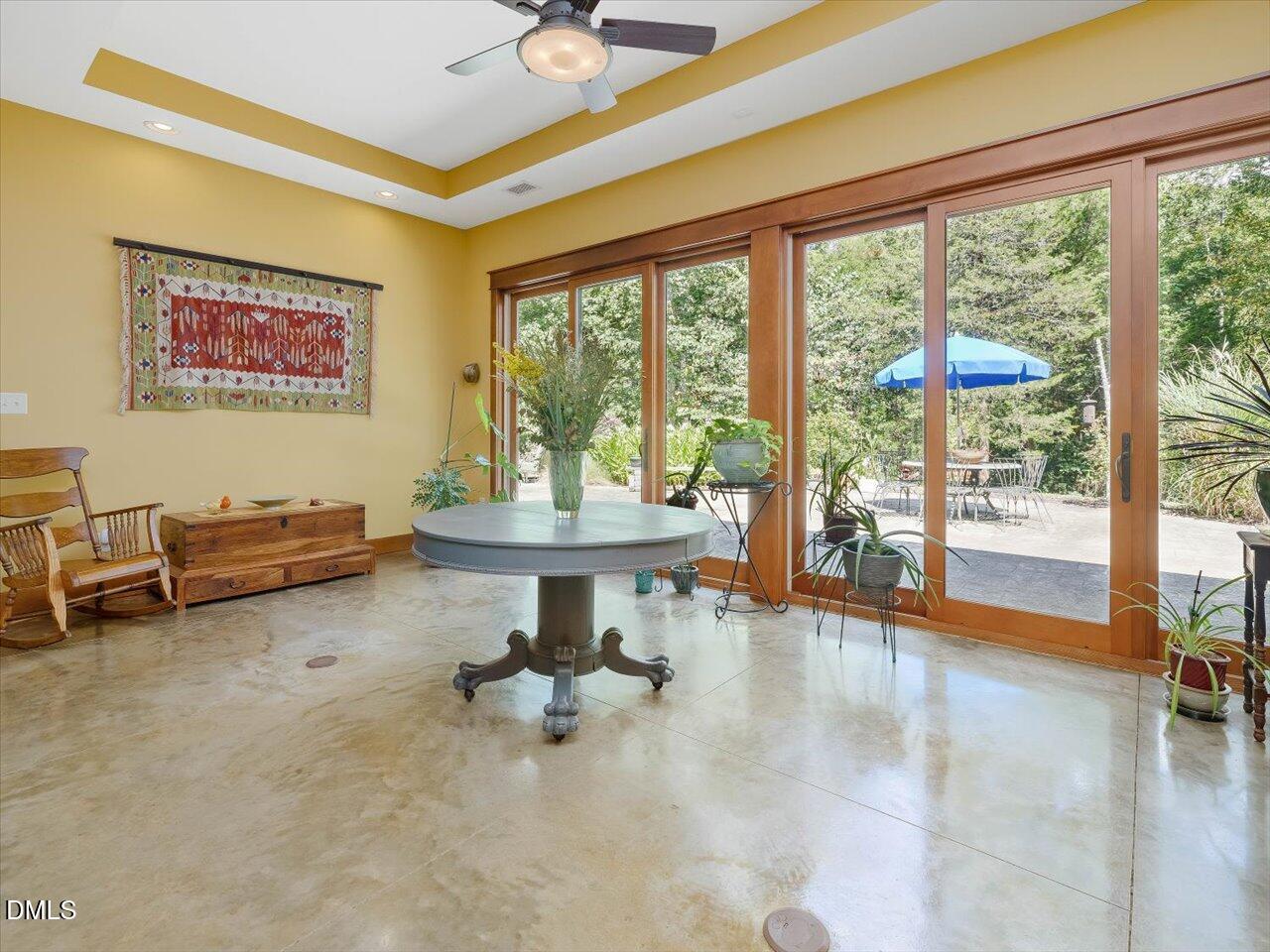 1210 Manco Dairy Road Pittsboro, NC 27312 - Photo 26 of 99 a living room with furniture and a floor to ceiling window