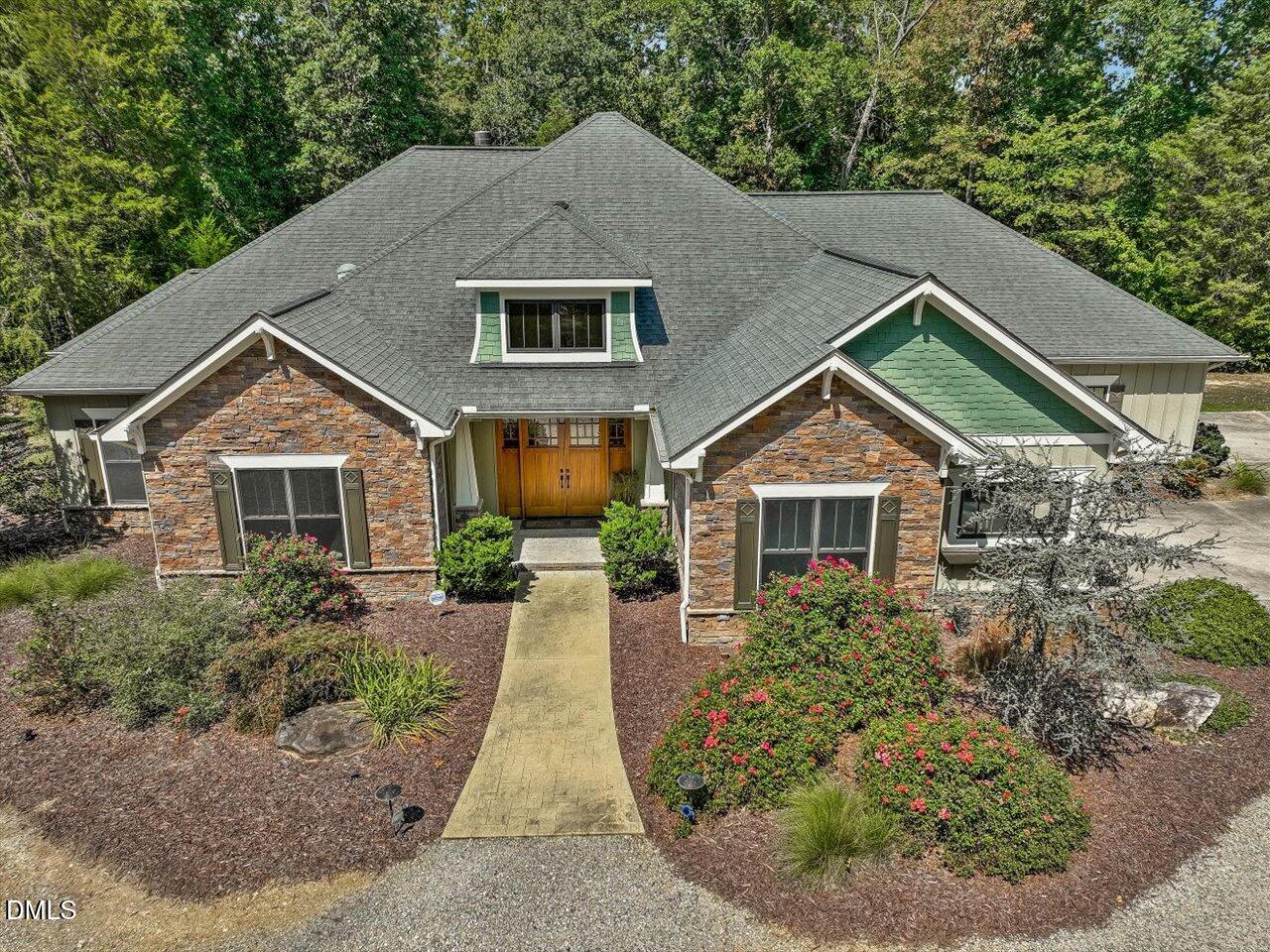 1210 Manco Dairy Road Pittsboro, NC 27312 - Photo 2 of 99 a front view of a house with a yard and garage