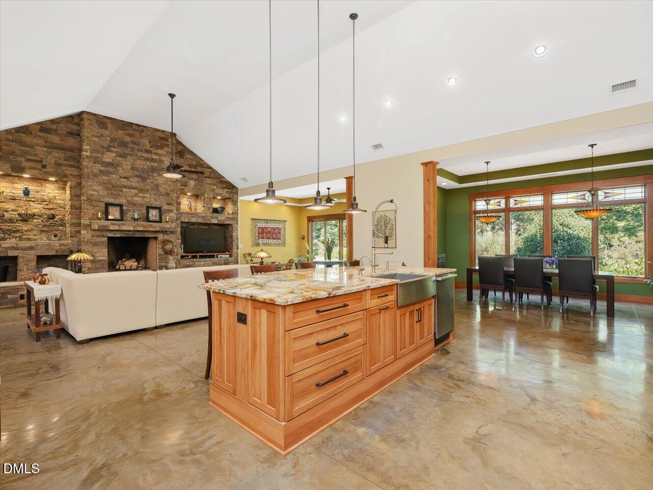 1210 Manco Dairy Road Pittsboro, NC 27312 - Photo 32 of 99 a kitchen with stainless steel appliances granite countertop a stove and a view of living room