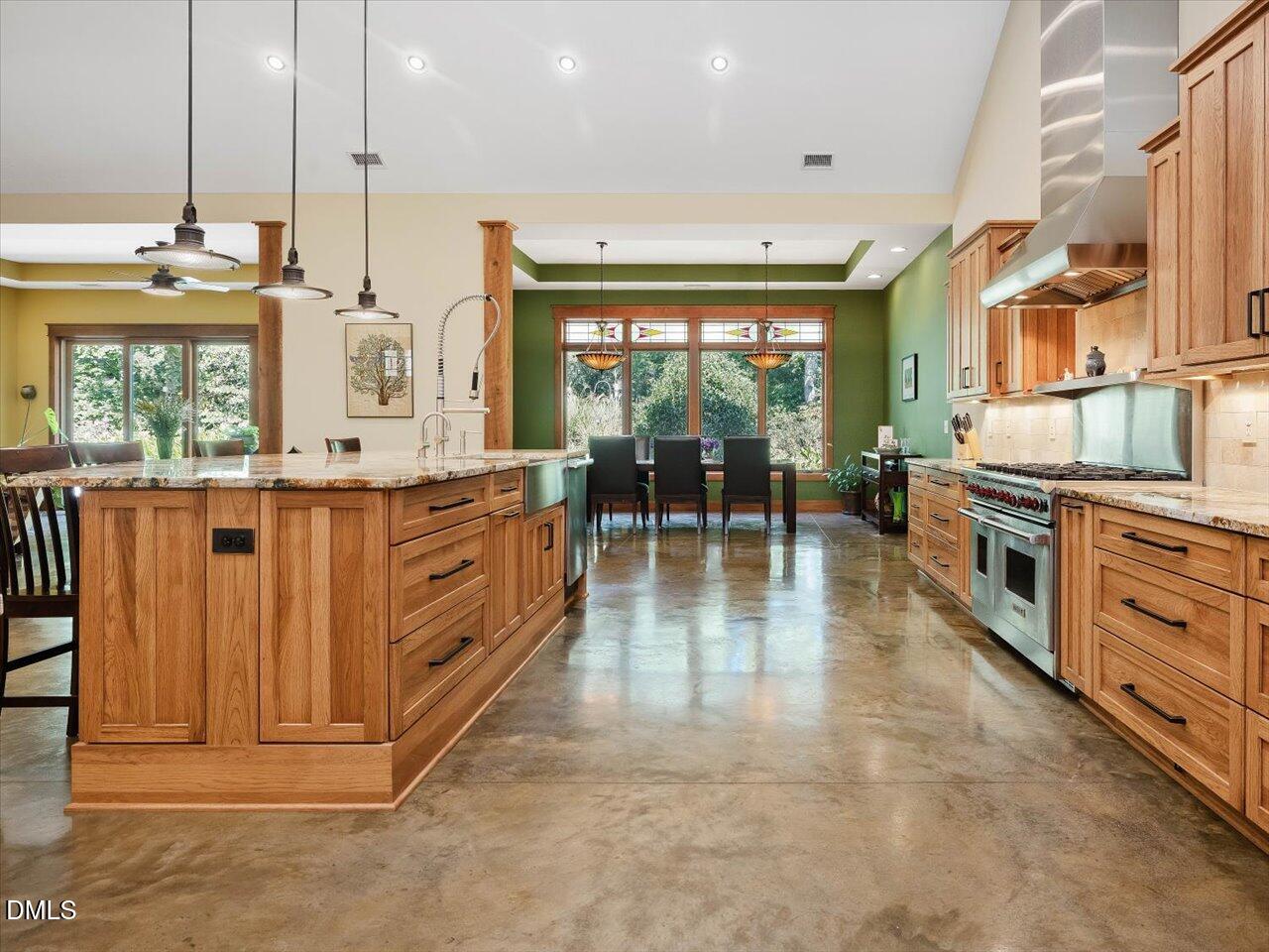 1210 Manco Dairy Road Pittsboro, NC 27312 - Photo 42 of 99 a kitchen with stainless steel appliances kitchen island granite countertop a stove a sink and a refrigerator