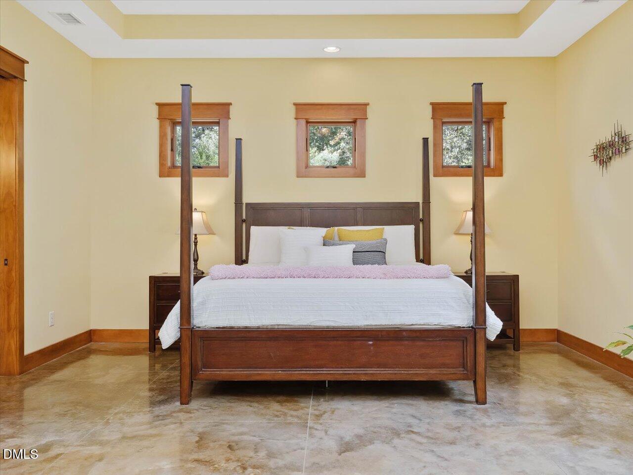 1210 Manco Dairy Road Pittsboro, NC 27312 - Photo 52 of 99 a bedroom with a bed table and wall painting