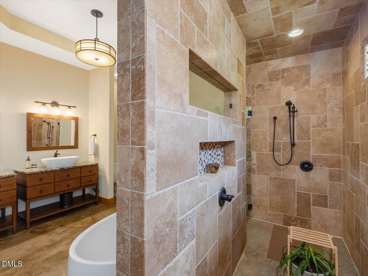 1210 Manco Dairy Road Pittsboro, NC 27312 - Photo 62 of 99 a bathroom with a double vanity sink a toilet a mirror and shower