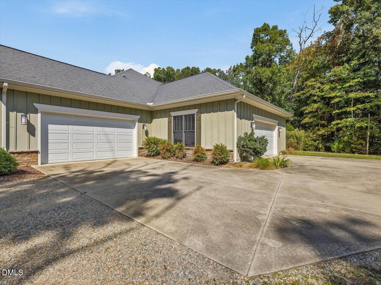 1210 Manco Dairy Road Pittsboro, NC 27312 - Photo 76 of 99 a view of a house with a yard and garage