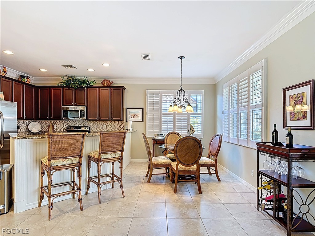 20763 Athenian Lane North Fort Myers, FL 33917 - Photo 14 of 49 a living room with lots of furniture and kitchen view