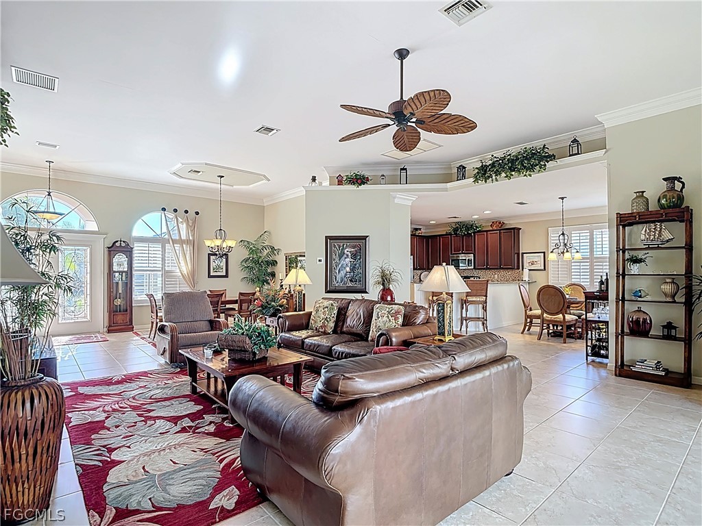 20763 Athenian Lane North Fort Myers, FL 33917 - Photo 18 of 49 a living room with furniture kitchen view and a chandelier