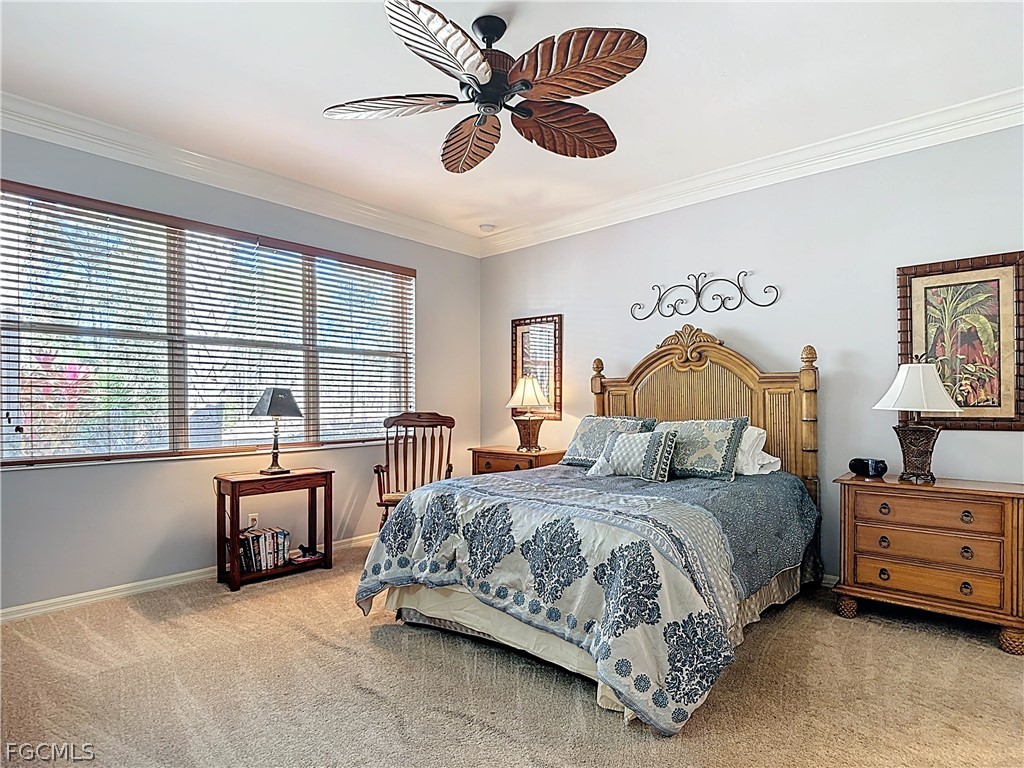 20763 Athenian Lane North Fort Myers, FL 33917 - Photo 28 of 49 a bedroom with a bed and a chandelier
