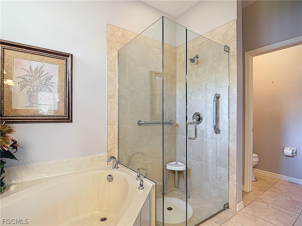 20763 Athenian Lane North Fort Myers, FL 33917 - Photo 32 of 49 a bathroom with a bathtub and a shower