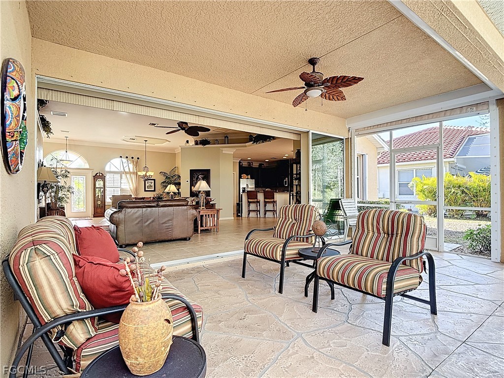 20763 Athenian Lane North Fort Myers, FL 33917 - Photo 37 of 49 a living room with furniture and a floor to ceiling window