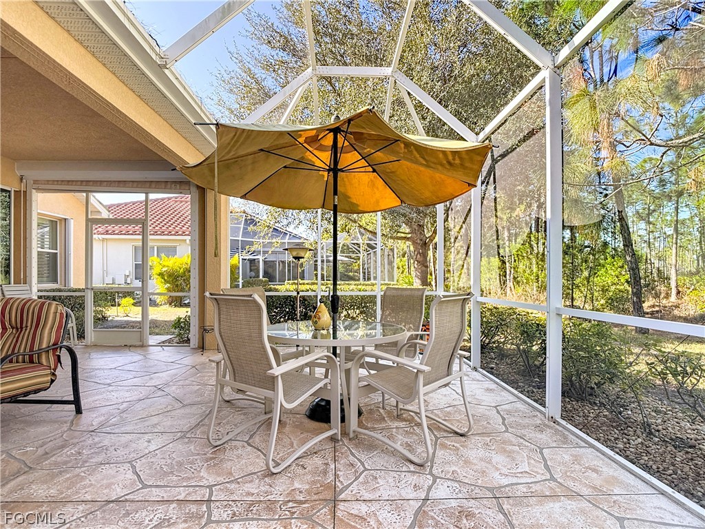 20763 Athenian Lane North Fort Myers, FL 33917 - Photo 40 of 49 a view of a patio with a table and chairs under an umbrella