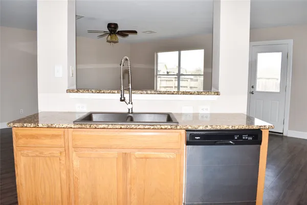 a bathroom with a granite countertop sink a mirror and a bathtub