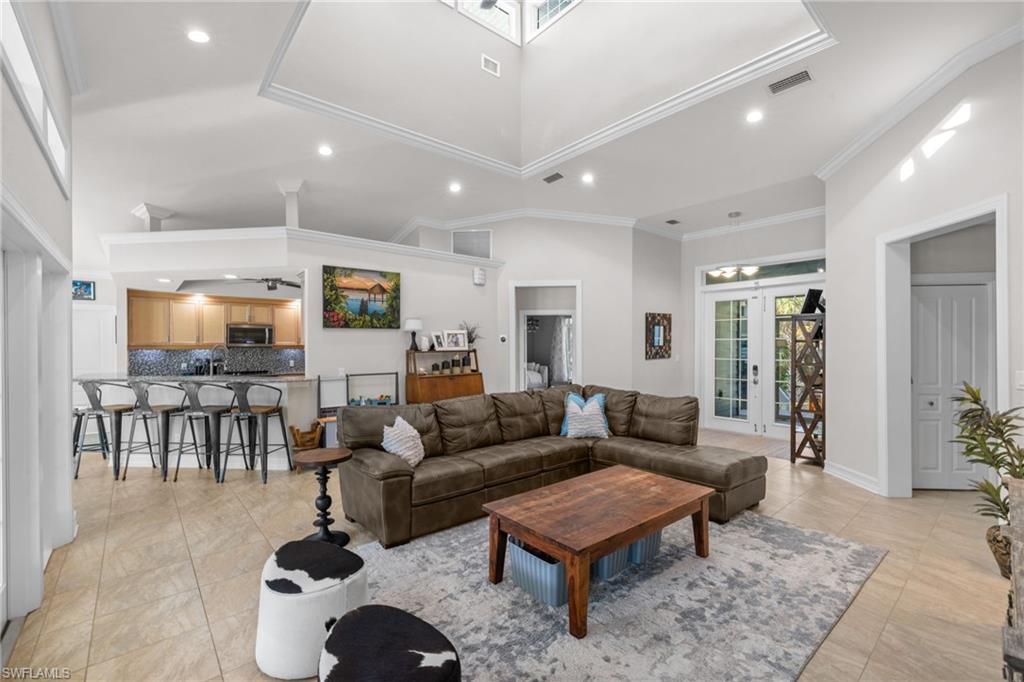 911 Mingo Drive Naples, FL 34120 - Photo 11 of 50 a living room with lots of furniture and a rug