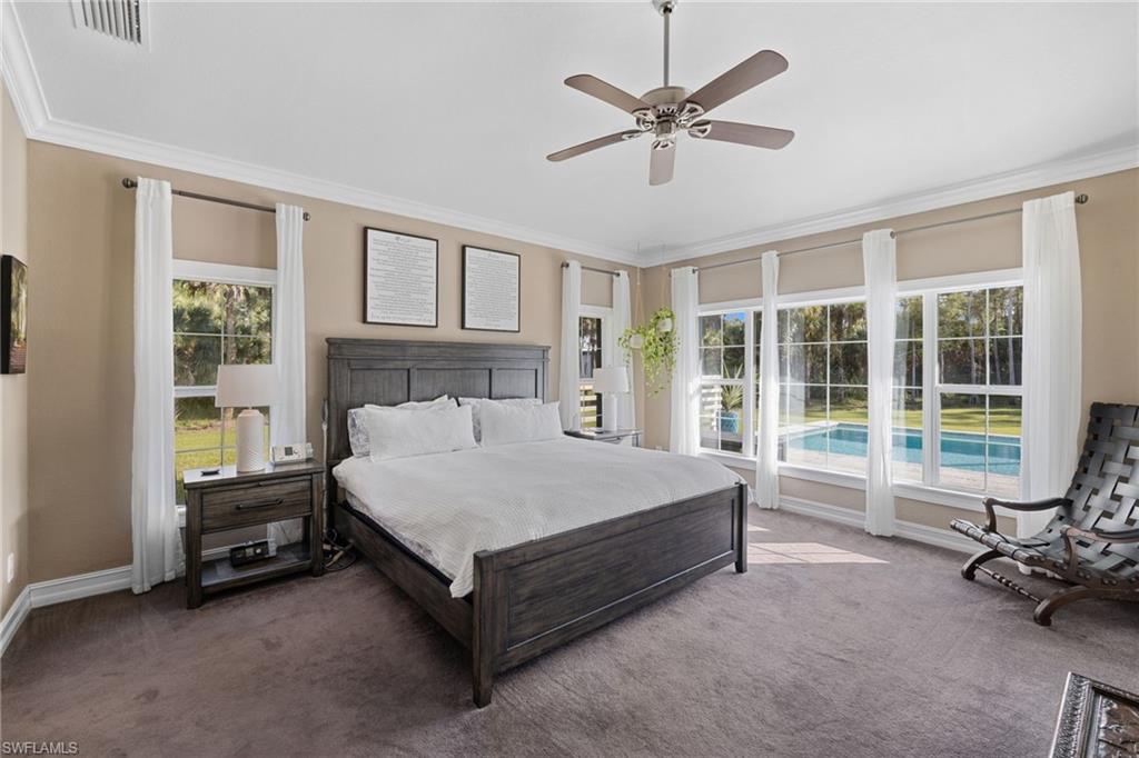 911 Mingo Drive Naples, FL 34120 - Photo 12 of 50 a bed sitting in a spacious bedroom next to a window