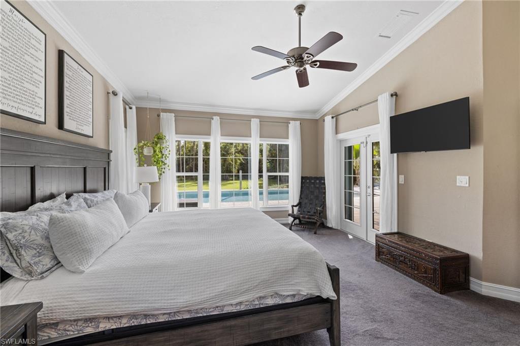 911 Mingo Drive Naples, FL 34120 - Photo 13 of 50 a large bed sitting in a living room next to a window